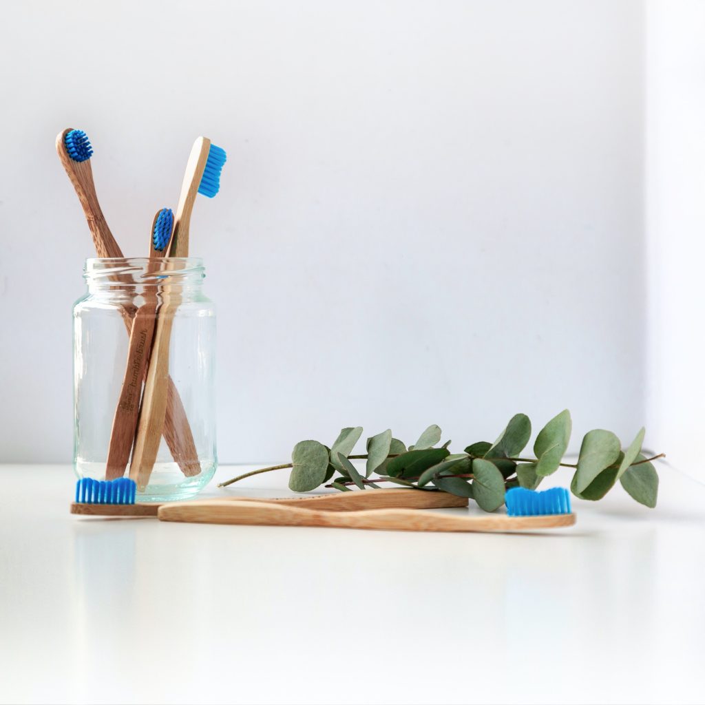 wooden toothbrushes in a jar