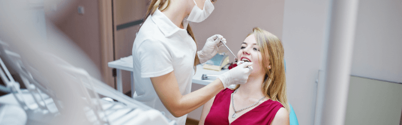 A dental hygienist cleaning teeth.