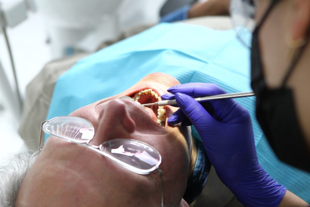 dentist looking at a patient’s mouth