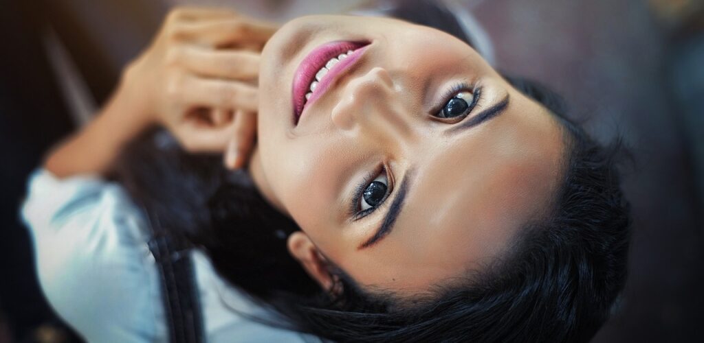 woman smiling while looking up at camera