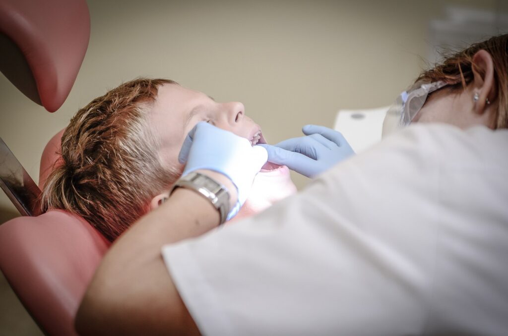 boy being examined by a dentist